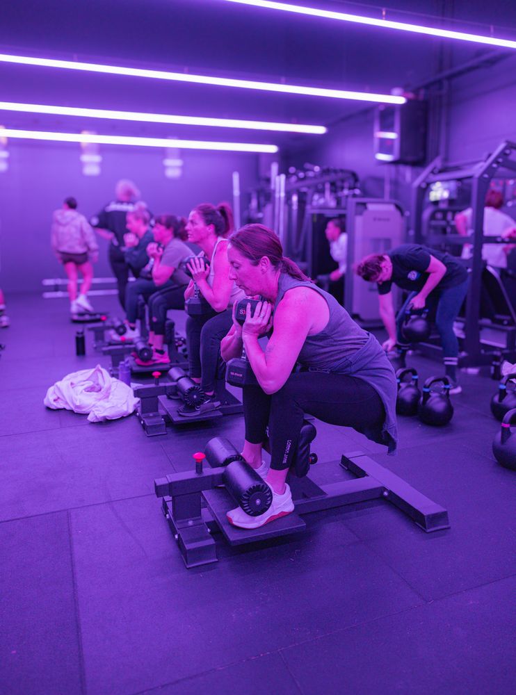 Member doing a dumbbell squat in class