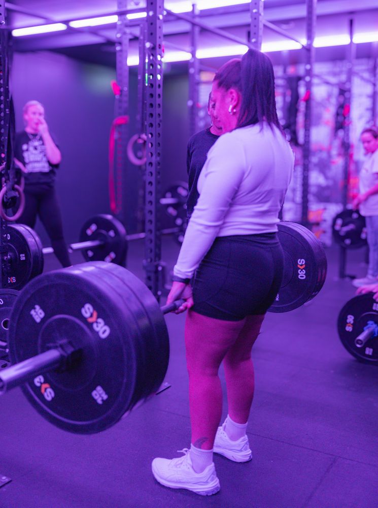 Member deadlifting during a session